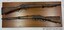 Two rifles mounted on a wooden board, one above the other