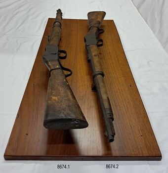 View along the rifles from above at an angle, top rifle on the left