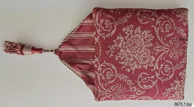Crimson and cream floral topped cover with triangular flap and tassel