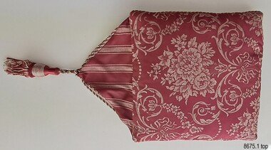 Crimson and cream floral topped cover with triangular flap and tassel
