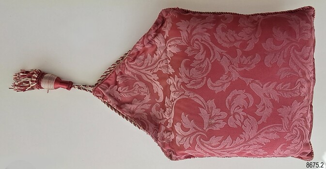 Crimson and cream floral top of cover with triangular flap and tassel