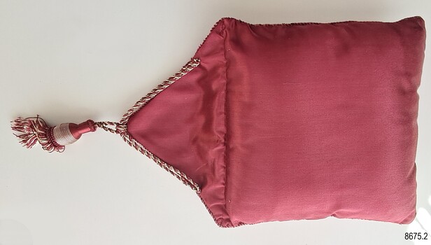 Plain crimson cover with triangular flap and tassel