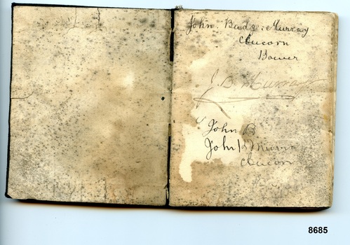 Flyleaf and first page of notebook showing spotting and name and address of owner written in cursive script.