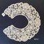 Round lace collar with flower motifs that include tulip shapes in groups of three. 
