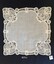 Fine hanky with intricate lace pattern in each corner.