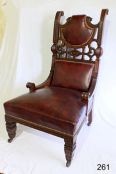 Wooden frame armchair with red upholstery and cutout out work