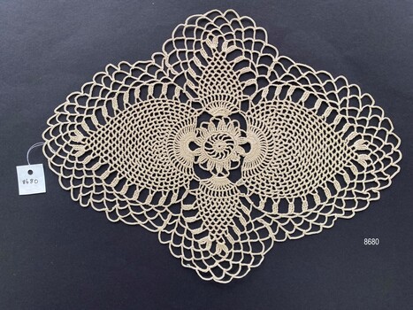 Crocheted doily in the pineapple pattern style.
