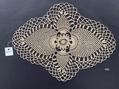 Crocheted doily in the pineapple pattern style.