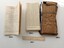 Brown waterproof packet with paper booklet and folded chart and ruler