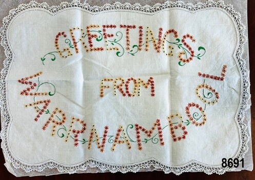 Rectangular tray cloth with crocheted edging and embroidered message.