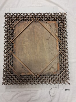 Wooden back of oil painting and back of frame showing diagonal wooden struts and length of wire