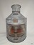Front of upright metal lamp with ribbed glass front, inscription plaques