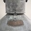 Close-up of the top crescent-shaped brass plaque on the lamp