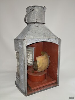 Back panel is removed, brass oil burner and shield are revealed