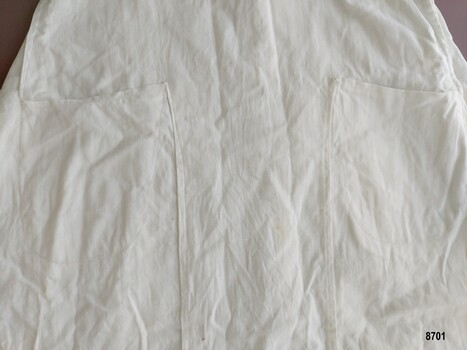 Two pockets set into front panel of overskirt.