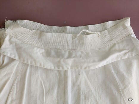 Waistband of overskirt showing hanging loop and grosgrain ribbon band.