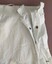 Opening of overskirt with hook and eye and snap fasteners.