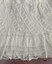 Decorative lace border on petticoat.