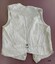Back of cream cotton waistcoat with fabric strap and metal buckle.