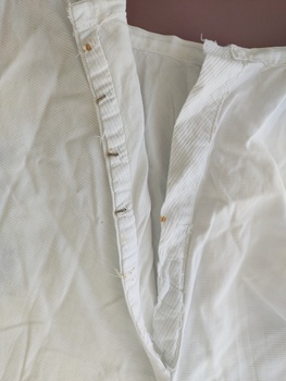 View of waistband opening with remaining hook and eyes