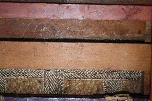handwritten inscription on base of chair