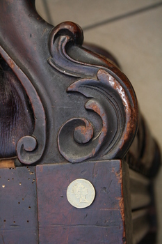 Elaborate carving on the chair's armrest