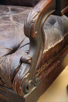 Carved front on wooden armrest