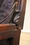 Carving at the back of the chair's armrest