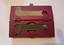 Red wooden box with fitted cutout inside for key spanner