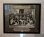 Group photograph in black frame behind glass - WFB