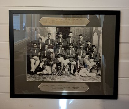 Group photograph in black frame behind glass - WFB