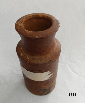 Brown stoneware ink bottle with straight sides and slightly fluted neck