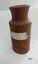 Brown stoneware ink bottle with straight sides and remnant of tape on one side