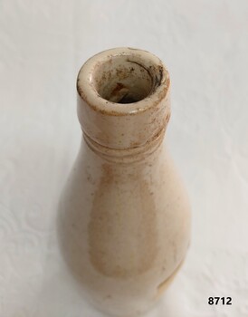 Neck and top opening of stoneware bottle with missing stopper.