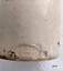 Oval shaped stamp with Makers' name and location on bottom side of bottle.