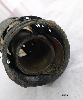 Outer and inner rusted and fragile blue - green metal tubes of telescope.