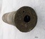Brass cylinder with a small circular hole in the end.