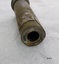 Brass cylinder with circular hole on the end.