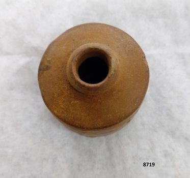 Top view of clay inkpot showing small round opening and round shoulders.