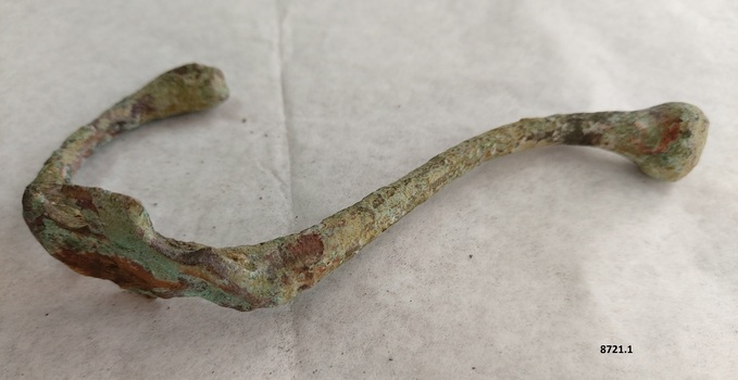 Brass coat hook with extensive verdigris patina and attachment plate (with screw holes) broken on both sides of main shaft.