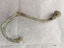 Brass coat hook with extensive verdigris patina and attachment plate (with four screw holes) missing.