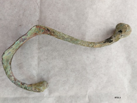 Brass coat hook with extensive verdigris patina and attachment plate (with four screw holes) missing.