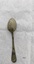 Back of teaspoon with rounded handle and small amount of tarnish.