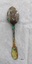 Back of dessert spoon, with fiddle back handle. Has green, purple and brown tarnish and corrosion.