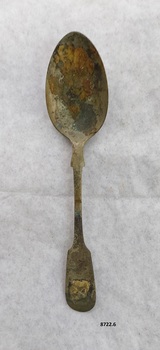 Spoon with fiddle back design on both ends of handle and has brown and some green oxidation.