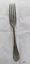 Large dinner fork with green and brown patina.