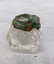 Square glass inkwell with verdigris oxidation on collar and hinge.