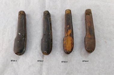 Four pocket knives, all of a similar design, showing different degrees of damage and wear.