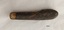 Other side of pocket knife showing a thin crack across the top of the brown handle.