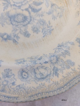 View of blue floral design on rim of plate